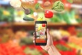 Vegetables fall in mobile phone. Buying fresh organic vegetables concept