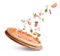 Vegetables fly to pizza on a white background Royalty Free Stock Photo