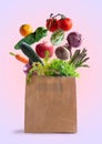 Vegetables flying in recyclable paper bag