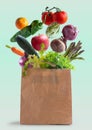 Vegetables flying in recycled paper bag