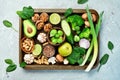 Vegetables, fruits, nuts and mushrooms on a metal tray. Healthy food. On a gray stone background. Royalty Free Stock Photo