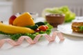 Vegetables and fruits for weight loss on a plate with a measuring tape in the kitchen Royalty Free Stock Photo