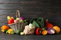 Vegetables, fruits, wicker basket and paper bag on wood background Royalty Free Stock Photo