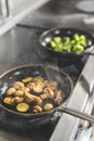 vegetables on frying pans on stove