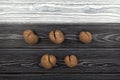 Vegetables of a funny form. Five ugly potatoes on a black and white wooden background. Top view