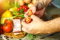 Vegetables and hands holding a sliced tomato Royalty Free Stock Photo