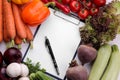 Vegetables including lettuce leaves onion pepper beetroot carrots zucchini and tomatoes with a blank for recipes or for writing Royalty Free Stock Photo