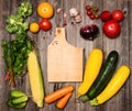 Vegetables and ingredients for cooking around cutting board on r Royalty Free Stock Photo