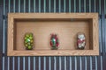 Vegetables lemons, chilli, garlic in glass jar on wooden shelf.