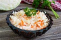 Vegetables lenten salad from cabbage. Sauerkraut in bowls on a wooden table