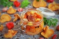 Vegetables and mushrooms chanterelles in a glass jar