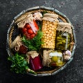 Vegetables and mushrooms in glass jars, food stocks. On a black background. Royalty Free Stock Photo