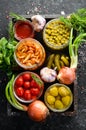 Vegetables and mushrooms in glass jars, food stocks. On a black background. Royalty Free Stock Photo