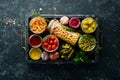 Vegetables and mushrooms in glass jars, food stocks. On a black background. Royalty Free Stock Photo