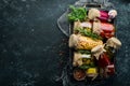 Vegetables and mushrooms in glass jars, food stocks. On a black background. Royalty Free Stock Photo