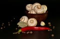 Vegetables. Mushrooms on a plate red hot pepper garlic and spice on a dark background