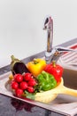 Vegetables near to steel faucet