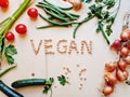 vegetables placed on the table in the kitchen and written vegan made with chickpeas Royalty Free Stock Photo