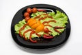 Vegetables on a plate laid out in the shape of a scorpion