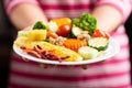 Vegetables salad holding by hand Royalty Free Stock Photo