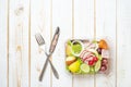 Vegetables salad in plastic bowl on white wood table Royalty Free Stock Photo