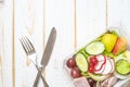 Vegetables salad in plastic bowl on white wood table Royalty Free Stock Photo