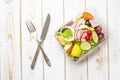 Vegetables salad in plastic bowl on white wood table Royalty Free Stock Photo