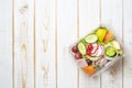 Vegetables salad in plastic bowl on white wood table Royalty Free Stock Photo