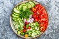 Vegetables Salad, Vegan Plate of Fresh Sliced Cucumbers, Green Onions, Radish, Cherry Tomatoes Royalty Free Stock Photo