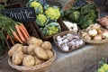 Vegetables for sell in vintage french street market. Potatoes, carrots,green cauliflower,garlic, onions and cabbage in baskets Royalty Free Stock Photo