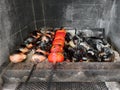 Vegetables on skewers are fried on coals. Onions, tomatoes, grilled eggplant.