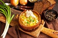 Vegetables soup with cabbage in bowl on wooden table Royalty Free Stock Photo