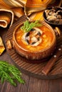 Vegetables soup with cabbage and mushrooms in bowl on wooden table Royalty Free Stock Photo