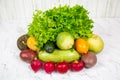 Vegetables stacked in tiers carrots cucumbers tomatoes radishes potatoes radish salad on a white marble table. Vegetables, fruits Royalty Free Stock Photo