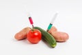 Vegetables and syringe with nitrates. Royalty Free Stock Photo