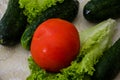 Vegetables on the table. Cucumbers, tomato and salad. close-up.