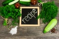 Vegetables, tomato, cucumber, courgette, dill and parsley on wooden background. Recipe table cuisine Royalty Free Stock Photo