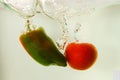 Vegetables tomato and paprika in water splash on white Royalty Free Stock Photo