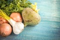 Vegetables on a wooden background, a retro style, onions, greens, garlic, radish