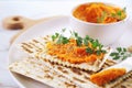 Vegetarian appetizer. Carrot dip on dry bread, sesame dressing