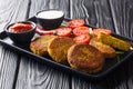 Vegetarian Asian yellow pea fritters with sauces close-up in a plate. Burma food. horizontal