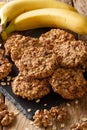 Vegetarian banana cookies with oatmeal and nuts close-up on the table. vertical