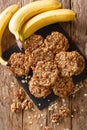 Vegetarian banana cookies with oatmeal and nuts close-up on the table. Vertical top view Royalty Free Stock Photo