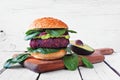 Vegetarian beet burger on a wooden board against white wood