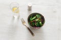 Vegetarian biodynamic food. Bowl salad spinach, beet leaves, water, lemon