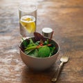 Vegetarian biodynamic food. Bowl salad spinach, beet leaves, water, lemon