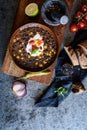 Vegetarian black bean soup with corn, tomatoes and sour cream Royalty Free Stock Photo