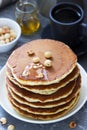 Vegetarian breakfast of pancakes, coffee, honey, nuts and fruits