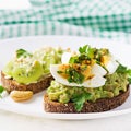 ndwich with avocado puree, boiled eggs and sandwich cream cheese, kiwi, nuts. Royalty Free Stock Photo