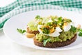 ndwich with avocado puree, boiled eggs and sandwich cream cheese, kiwi, nuts. Royalty Free Stock Photo